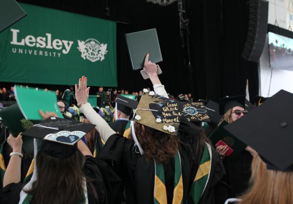 A view of the graduates in the audience with the Lesley banner in the background.