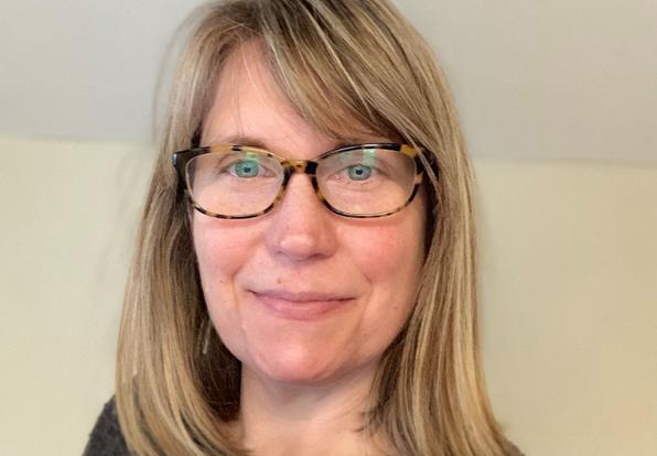 A headshot of Virginia Casey. She is a woman with shoulder length blonde hair and glasses