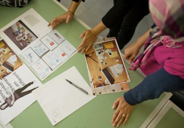students look over print design layouts
