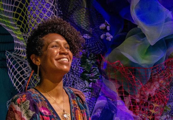 Cicely smiling in front of colorful background