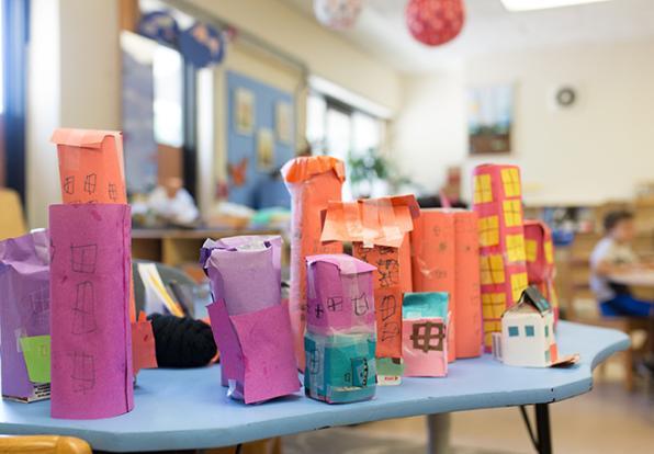 Early childhood classroom with table of colorful handmade paper structures