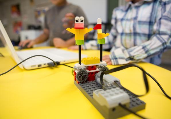 student playing on computer to move around a robot