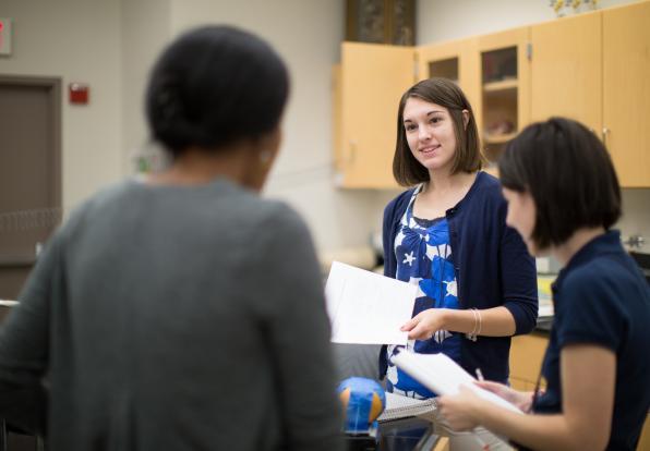 Hannah Willis speaking to her classmates in a lab