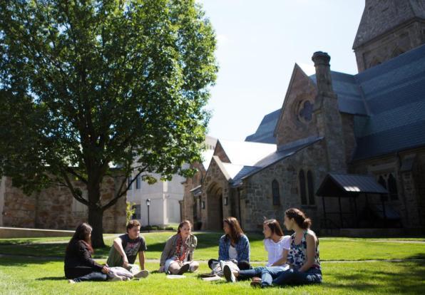 Students in an arc, chatting on Lesley's lawn.