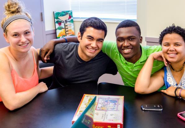 diverse students gathered a table