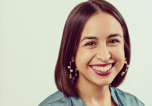 Jasmine smiling against off-white background