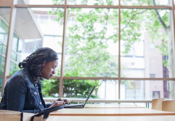A woman typing on a laptop
