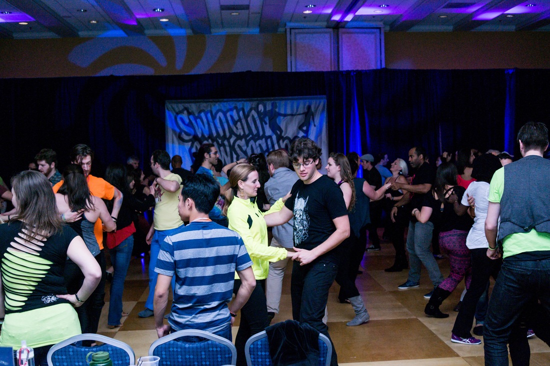 people dancing together on the dance floor 