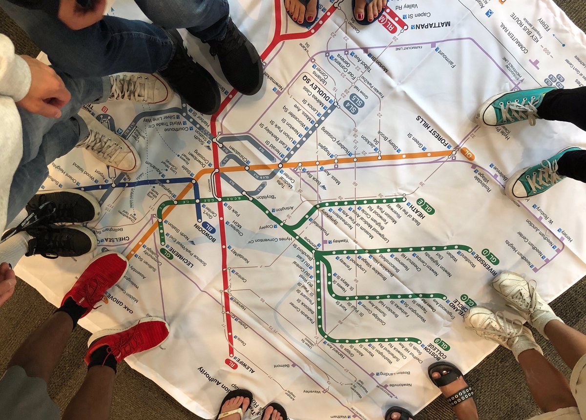 Photo of people standing on a large map of the Boston subway system