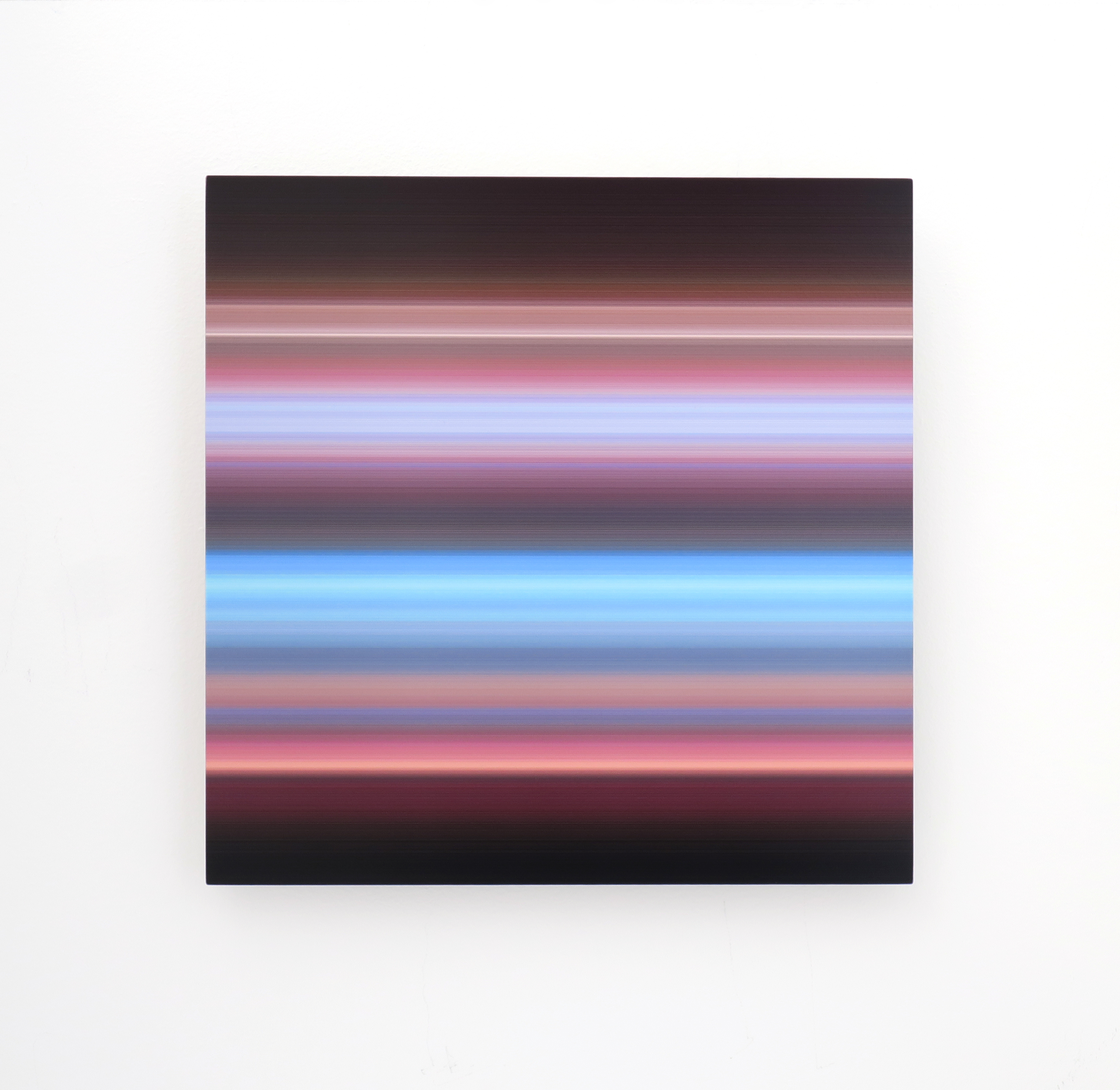 Fluorescent blue and pink light beams across a black background